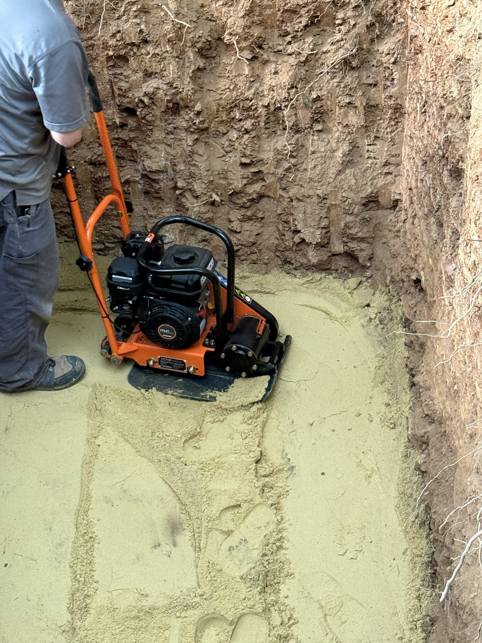 Sewer Excavation — Plate Compactor on Sand Bedding